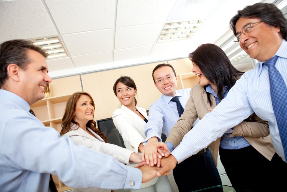 Business group with hands together in the middle - teamwork concepts