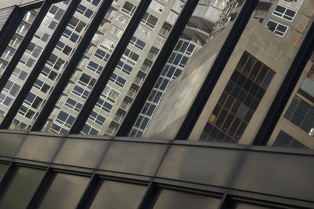 Condominiums and office building reflected by another office building